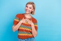 Photo of appreciative nice girlish woman with bob hairdo dressed knitwear t-shirt keep palms on chest isolated on blue Royalty Free Stock Photo
