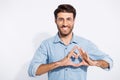 Photo of arabian amazing guy making heart form with fingers romance date invitation wear specs casual denim shirt