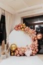 Photo area for the holiday. Festive photo area in the restaurant is decorated with inflatable layers, gold, pink, peach with