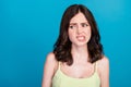 Photo of arrogant moody girl dressed green clothes biting lip looking empty space isolated blue color background