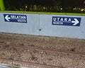 photo of arrow sign pointing north and south direction in railway station