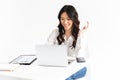 Photo of asian business woman 20s wearing office clothing looking at laptop, during video call or online conference, isolated Royalty Free Stock Photo