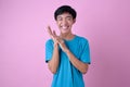 Photo of Asian man with laugh face, isolated on pink background