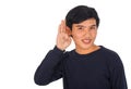 An Asianman in black shirt is covering his left ear with his han Royalty Free Stock Photo