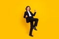 Photo of astonished crazy boy raise fists scream yeah wear black uniform isolated yellow color background Royalty Free Stock Photo