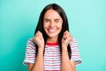 Photo of astonished dreamy lady closed eyes beaming smile raise fists wear striped t-shirt isolated teal color