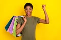 Photo of astonished excited person raise fist success achieve luck isolated on yellow color background