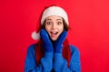 Photo astonished girl in santa claus headwear feel crazy magic miracle christmas season discount touch hands gloves face