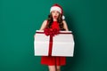 Photo of astonished girl in santa claus headwear hold big gift box she get receive on x-mas jolly holly newyear event