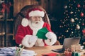 Photo astonished grey hair santa claus sit table in fairy north-pole house read x-mas christmas kid wish list impressed Royalty Free Stock Photo