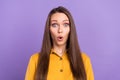 Photo of astonished millennial lady wear yellow shirt isolated on vivid violet color background