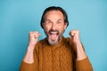 Photo of astonished person open mouth scream yeah fists up celebrate isolated on blue color background Royalty Free Stock Photo