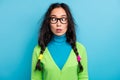 Photo of astonished speechless young schoolgirl wear glasses stand stupor isolated on bright blue color background