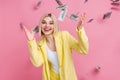 Photo of astonished successful pretty person flying falling dollar bills isolated on pink color background Royalty Free Stock Photo