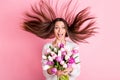 Photo of astonished young woman get flowers hair fly amazed gift isolated on pastel pink color background Royalty Free Stock Photo