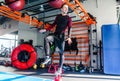 Athlete keeps balance while standing with one foot on a weight