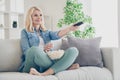 Photo of attractive aged mature homey domestic lady sitting comfy sofa couch legs crossed eat popcorn good mood relaxing Royalty Free Stock Photo