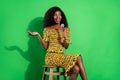 Photo of attractive black woman happy positive smile speak talk microphone performance isolated over green color