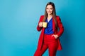 Photo of attractive business lady holding hot morning coffee mug enjoy amazing fresh beverage wear luxury trend red suit Royalty Free Stock Photo