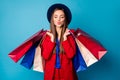 Photo of attractive business lady visiting shopping center holding many packs sending air kisses wear retro cap red suit Royalty Free Stock Photo