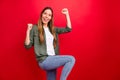 Photo of attractive charming fascinating girl dancing out of happiness while isolated with red background Royalty Free Stock Photo