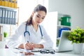 Photo of attractive concentrated female doctor writing prescript Royalty Free Stock Photo