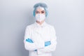 Photo of attractive confident virologist doctor lady arms crossed serious reliable professional wear medical coat mask