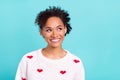 Photo of attractive dreamy afro girl wear heart print pullover smiling looking empty space isolated blue color