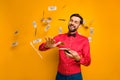 Photo of attractive elegant funny guy hold fan money bucks spending jackpot throwing away money falling wear trendy red