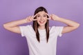 Photo of attractive girl showing v-sign face eyes on violet background