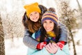 Photo of attractive girls cheerful mommy daughter happy positive smile hug cuddle embrace fly air snow walk park