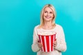 Photo of attractive lady wear shirt hold basket pop corn eating snacks looking empty space new film advertisement