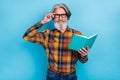 Photo of attractive man wear plaid shirt arm spectacles enjoying good story blue color background