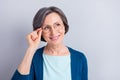 Photo of attractive nice dreamy old woman look empty space wear glasses isolated on grey color background