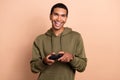 Photo of attractive positive man wear khaki trendy sweatshirt enjoy free time playstation new level isolated on beige