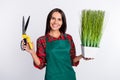 Photo of attractive pretty young woman hold green grass scissors work farmer isolated on grey color background