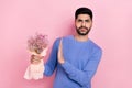 Photo of attractive serious arabian man wear long sleeve shirt dislike wildflowers isolated pink color background