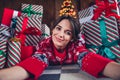 Photo of attractive young woman lying floor gift pile selfie dressed red sweater christmas room interior design tree Royalty Free Stock Photo