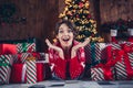 Photo of attractive young woman lying floor hands excited shocked dressed red sweater christmas room interior design Royalty Free Stock Photo