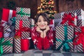 Photo of attractive young woman lying floor hands face admire dressed red sweater christmas room interior design tree Royalty Free Stock Photo