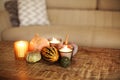 Photo of autumn decoration set of pumpkins and burning candles on wooden coffee table in living room Royalty Free Stock Photo