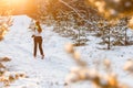 Photo from back of athlete running through winter forest