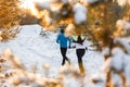 Photo from back of running two athletes in winter park Royalty Free Stock Photo