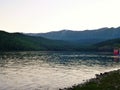 Photo with the background of lake Baikal in Russia, rocky shoreline and mountain peaks on the horizon