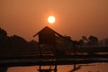 Photo Backlight Silhouette Southeast Asian wetland huts Royalty Free Stock Photo