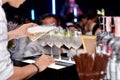Photo of barman hand holding bottle and pouring water out of it in party event Royalty Free Stock Photo