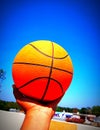 A photo of a basketball in hand.