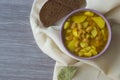 Photo bean soup in a plate and pieces of bread on a light napkin