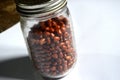 Photo of beans in a jar with a white background