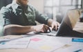 Photo bearded designer working with new project. Generic design notebook on wood table. Analyze plans, papers, hands Royalty Free Stock Photo